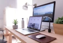 Digital Maturity MacBook Pro on table beside white iMac and Magic Mouse